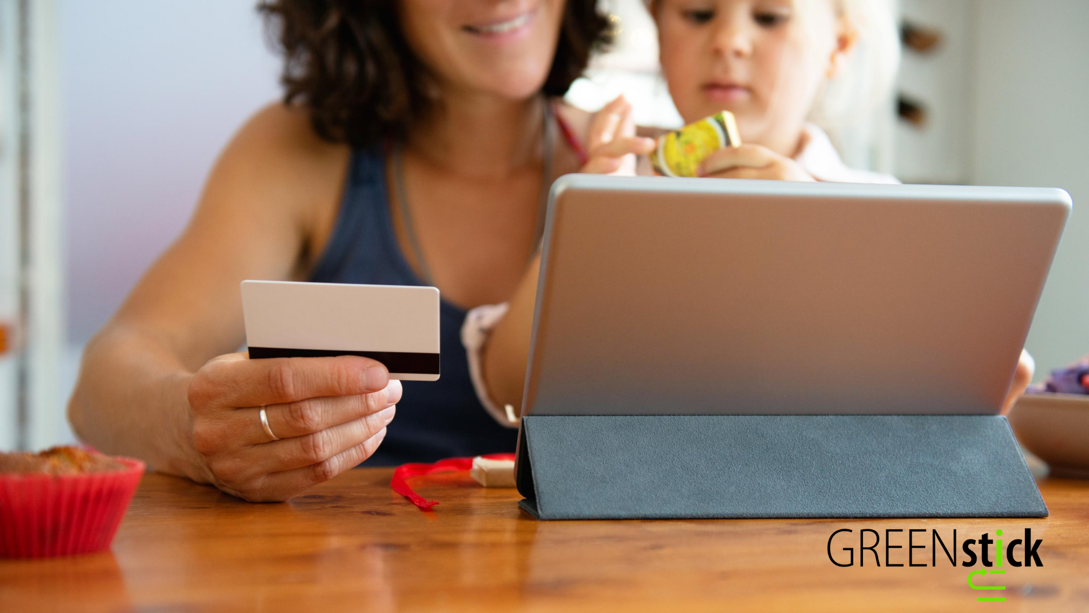 Green Stick Marketing, INC Adult women and baby girl shopping online on an ipad using a business gift card to complete their purchase.